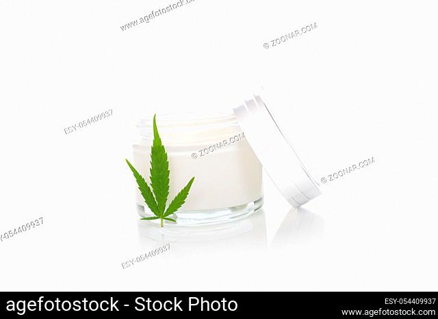 Moisturizing Hemp Hand Cream in dose with Cannabis leaf, isolated on white background. Cannabis cosmetics