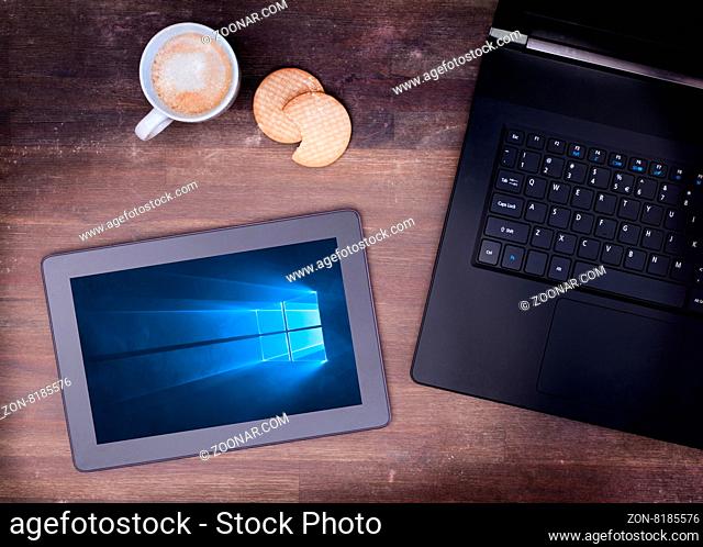 HEERENVEEN, NETHERLANDS, June 6, 2015: Tablet computer with Windows 10 background. Windows 10 is the new version of Windows OS by Microsoft Corporation; it...