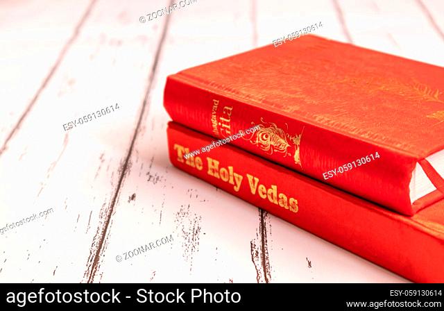 Holy Bhagavad gita and The Holy Veda on wooden textured background