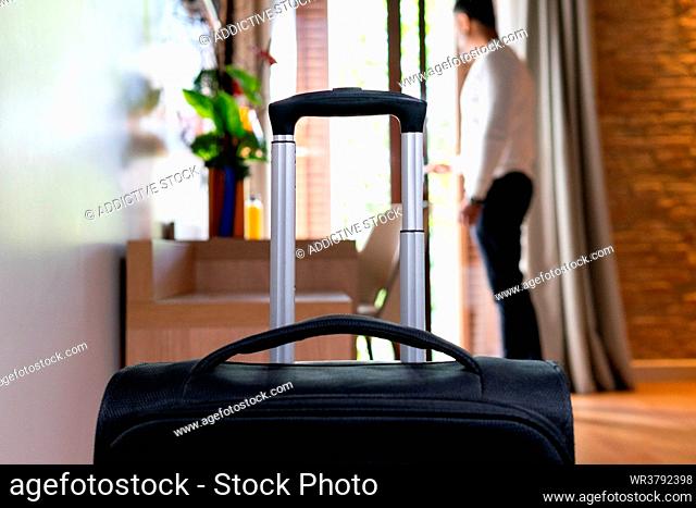 tourist, hotel room, rolling suitcase