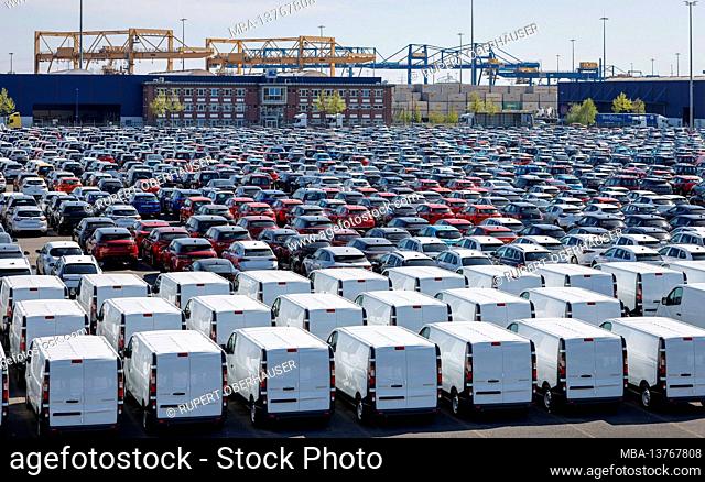 Duisburg, North Rhine-Westphalia, Germany - new cars, cars and vans, car terminal in the port of Duisburg, behind cranes in the container port
