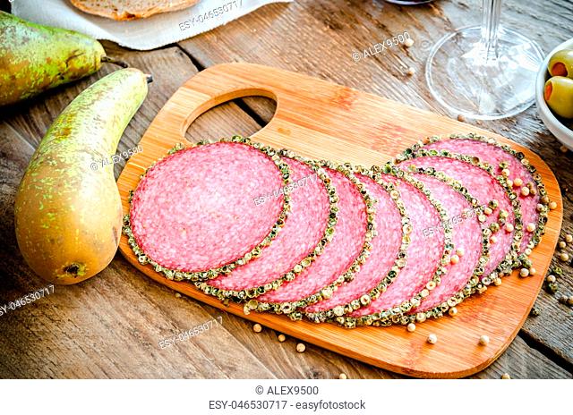 Slices of italian salami with pears