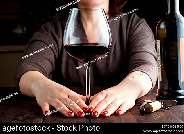 Woman drinking wine in kitchen