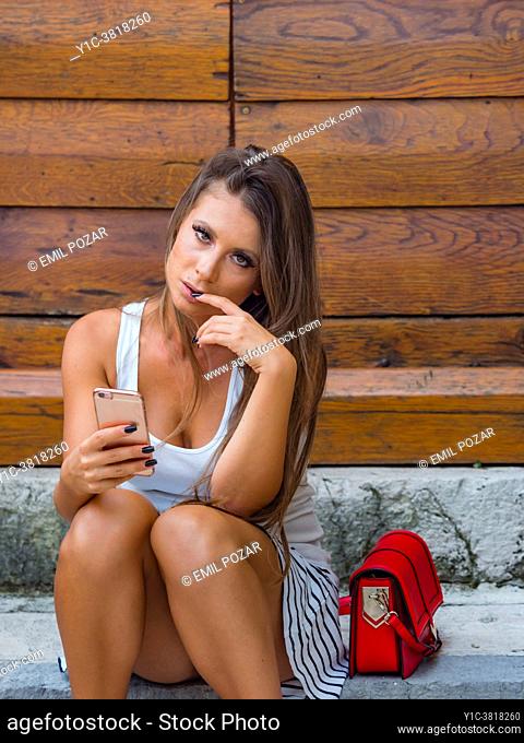 Young woman concerned worried finger in mouth
