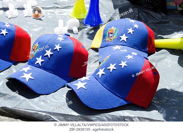 Baseball cap with the flag of Venezuela, used as a sign of the Venezuelan opposition, is sold on the street in a march against the government