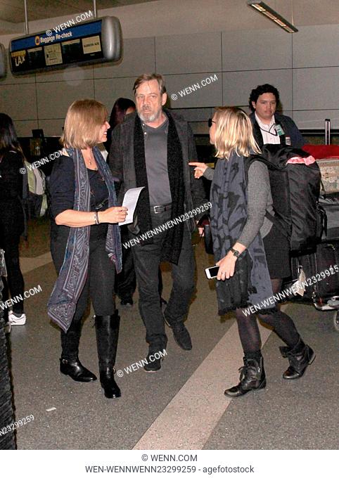 Mark Hamill is swarmed by 'Star Wars' fans as he arrives at Los Angeles International Airport (LAX) with his wife Marilou York and daughter Chelsea Hamill...