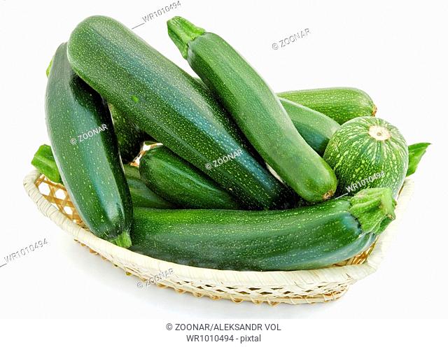 Fresh small green vegetable marrows in a wattled small basket