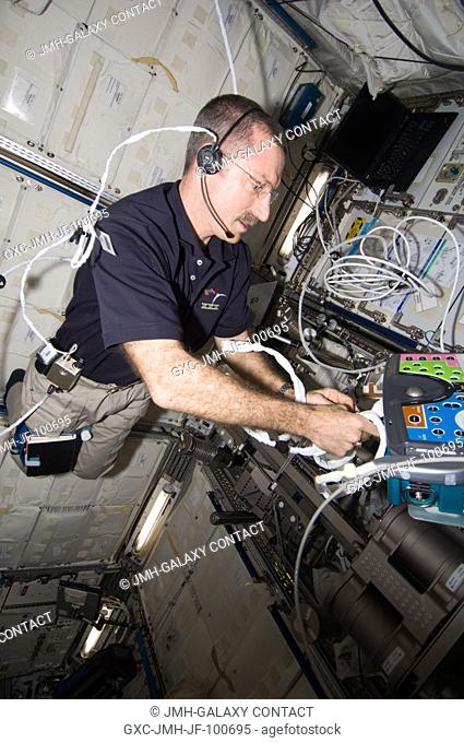 NASA astronaut Dan Burbank, Expedition 30 commander, sets up the Integrated Cardiovascular (ICV) Resting Echo Scan at the Human Research Facility (HRF) rack in...