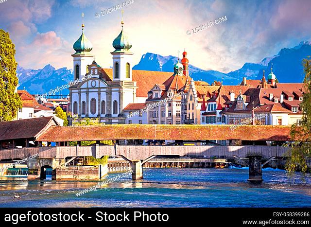 Luzern wooden river Bridge and church view, landmarks in town in central Switzerland