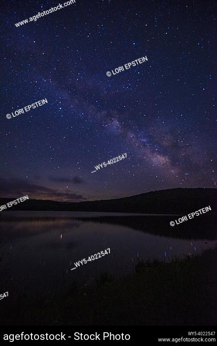 The Milky Way rises in the sky above Spruce Knob Lake