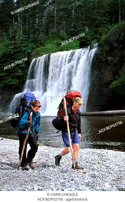 West Coast Trail - hikers at Tsusiat Falls, Vancouver Island, British Columbia, Canada