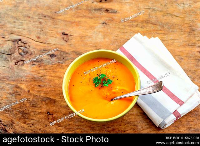 Curried carrot soup with cream and fresh herbs