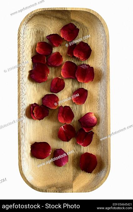 red rose petals on a wooden tray