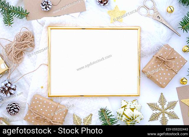Christmas golden frame made of christmas decoration, balls, cones, golden star, gift box and fir tree. Flat lay, top view