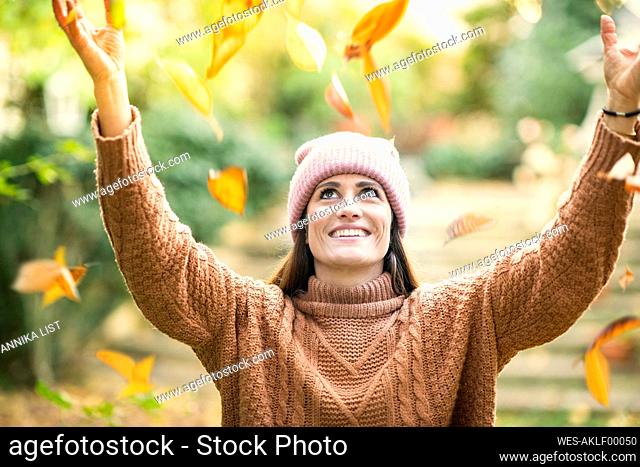 Smiling woman in knit hat enjoying autumn day
