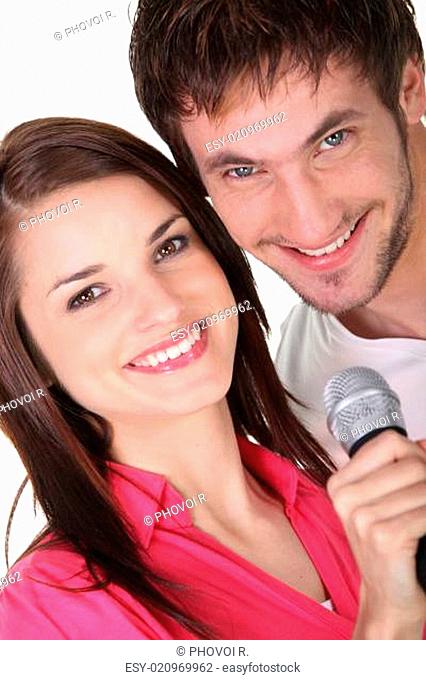 Couple singing into a microphone