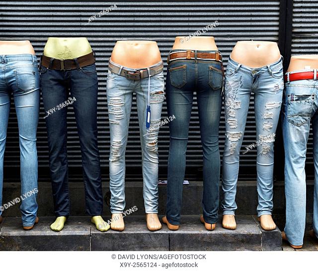 Blue denim jeans pants displayed on mannequin shop outfitters dummies outside tourist boutique in Antalya old town, Turkey