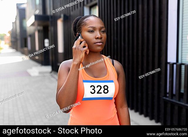 female marathon runner calling on smartphone
