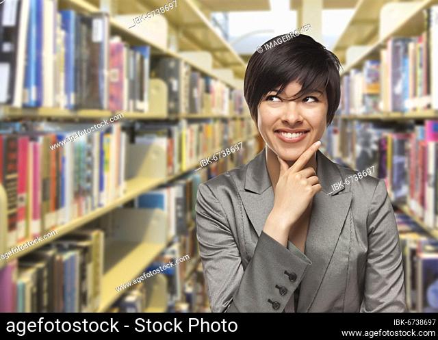 Curious mixed-race girl looking to the side in the library