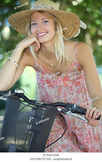 Woman with hat on a bicycle