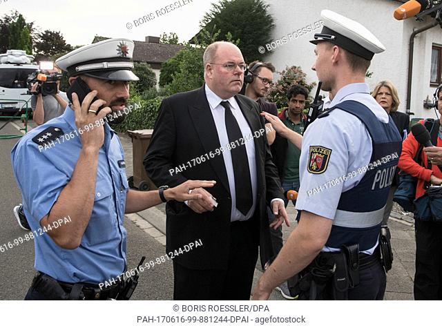 Walter Kohl (C), son of former German Chancellor Helmut Kohl, is temporarily held up by members of the German police as the area surrounding the residence of...