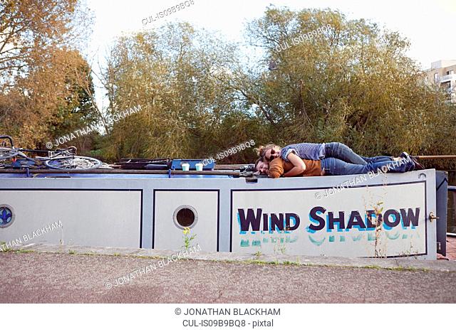 Couple lying on roof of canal boat