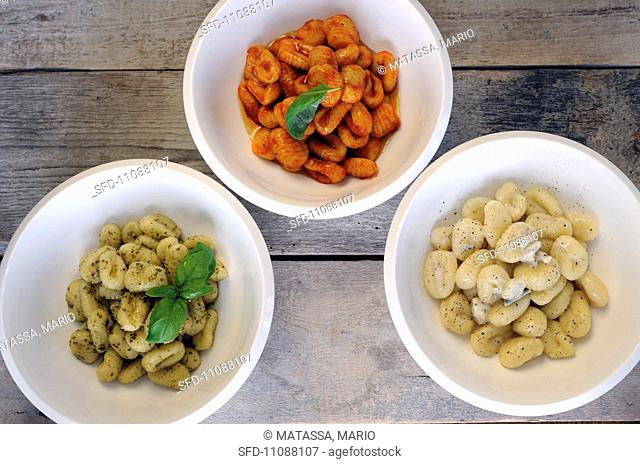 Fresh gnocchi with three different sauces seen from above