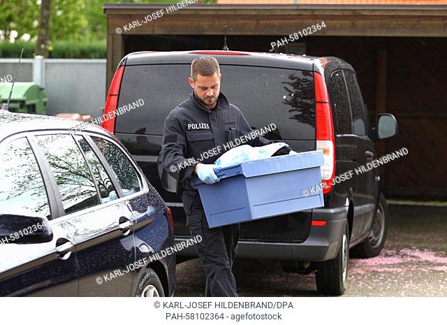 An investigator carries a box with seized items from an apartment of a man suspected of being a member of a right-wing extremist group in Augsburg, Germany