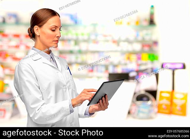 female doctor with tablet computer at pharmacy