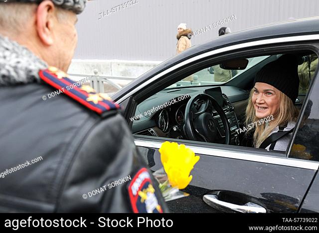 RUSSIA, YEKATERINBURG - MARCH 7, 2023: Pol Col Pavel Bondar congratulates a woman driver on 8 Marta Street ahead of International Women's Day