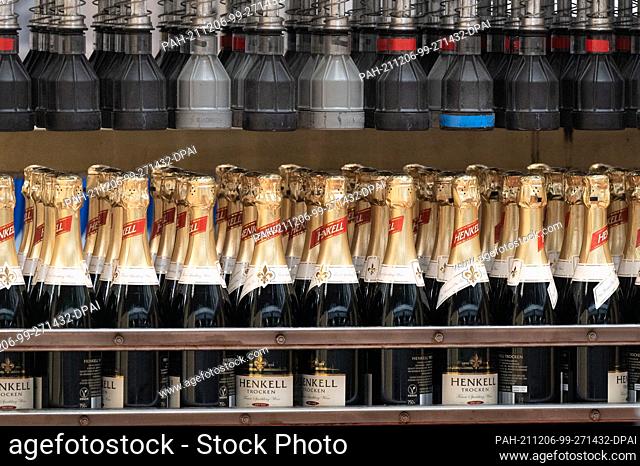 09 November 2021, Hessen, Wiesbaden: Sparkling wine bottles of Henkell Trocken are transported during production at the Henkell & Co
