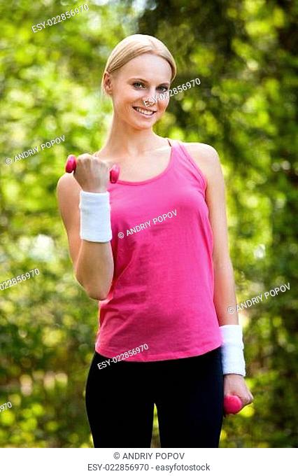 Young Woman Exercising With Dumbbells