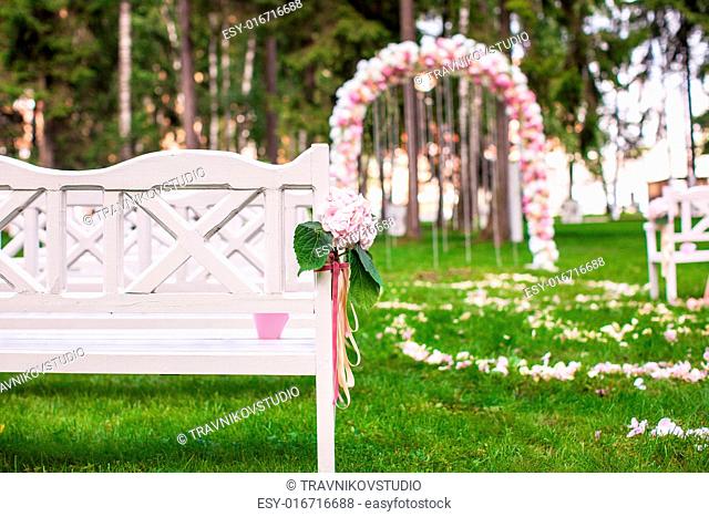 Wedding benches and flower arch for a wedding ceremony outdoors