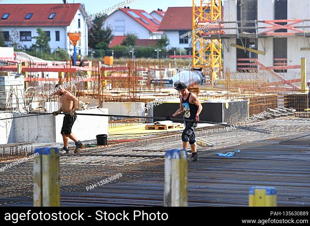 Construction workers on a large construction site, workers, new apartments, shell construction, scaffolding, reinforced concrete, steel, structural steel