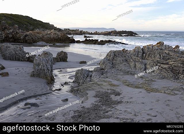 A deserted beach, jagged rocks and rockpools on the Atlantic coast