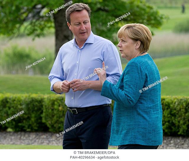 British Prime Minister David Cameron greets German Chancellor Angela Merkel (CDU, R) at the start of the G8 summit in Enniskillen