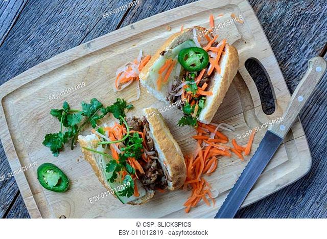 Vietnamese Grilled Pork Banh Mi Sandwich on Rustic Wood Backgrou