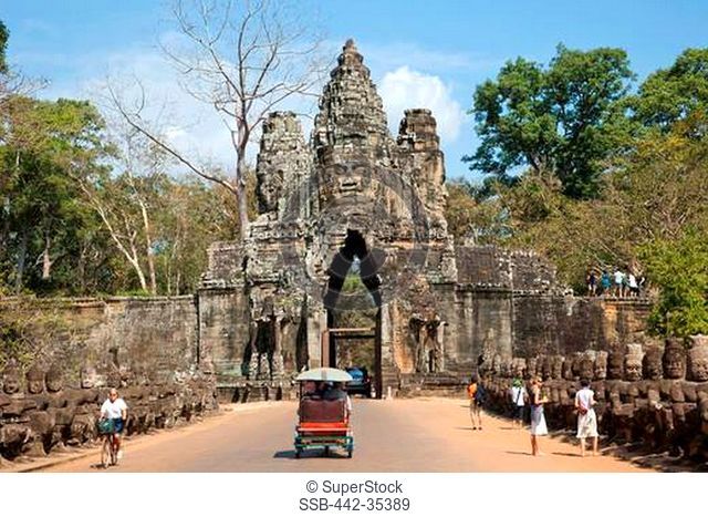 Tourists at the South gate of a temple, Angkor Thom, Angkor, Siem Reap, Cambodia