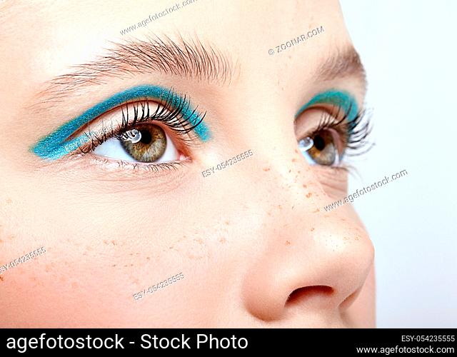 Closeup shot of human female face. Girl with perfect skin and blue smoky eyes eye shadows. Woman with vogue face beauty makeup