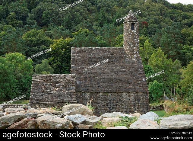 Glendalough, co. Wicklow, Ireland - August 10 2019 :Stone round tower and some ruins of a monastic settlement originally built in the 6th century in Glendalough...