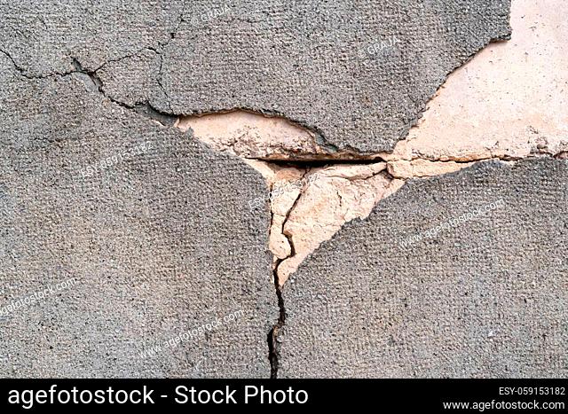 Cracked concrete wall covered with gray cement surface as background