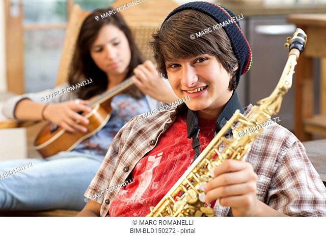 Mixed race teenagers playing musical instruments