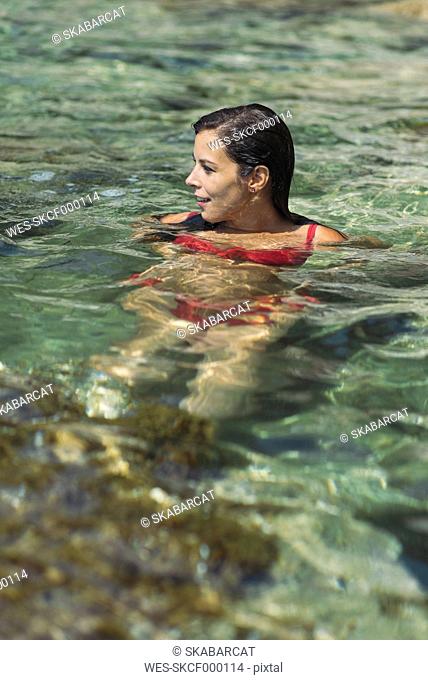 Woman in water, smiling