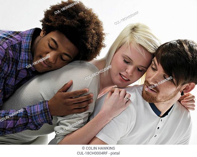 3 young people leaning on each other