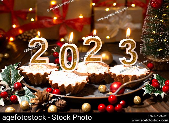 Food tray with cupcakes new year candles and christmas decorations