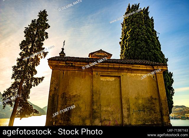 Church with Cypress Tree and Lake Lugano with Mountain and Blue Sky in Park San Michele in Castagnola in Lugano, Ticino in Switzerland