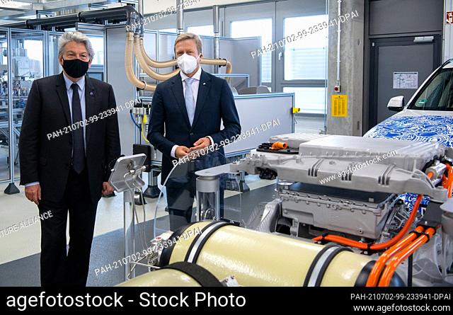 02 July 2021, Bavaria, Garching: Oliver Zipse (r), Chairman of the Board of Management of BMW AG, and EU Commissioner Thierry Breton visit the research centre...