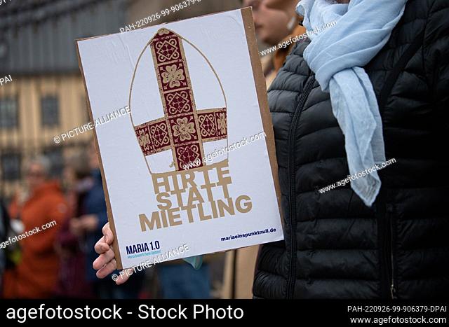 26 September 2022, Hessen, Fulda: An activist from the conservative Catholic initiative Maria 1.0 holds up a sign reading ""Shepherd not hireling"" in front of...
