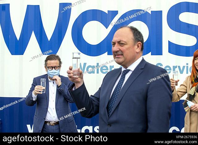 Belgian businessman Marc Coucke and Walloon Vice-Minister President Willy Borsus drink a glass of water at the opening of a wastewater recycling facility on the...