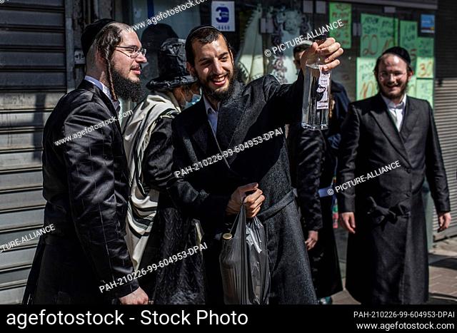 26 February 2021, Israel, Bnei Brak: Ultra orthodox Jewish men in traditional attires take part in celebrations marking Purim, also called the Festival of Lots